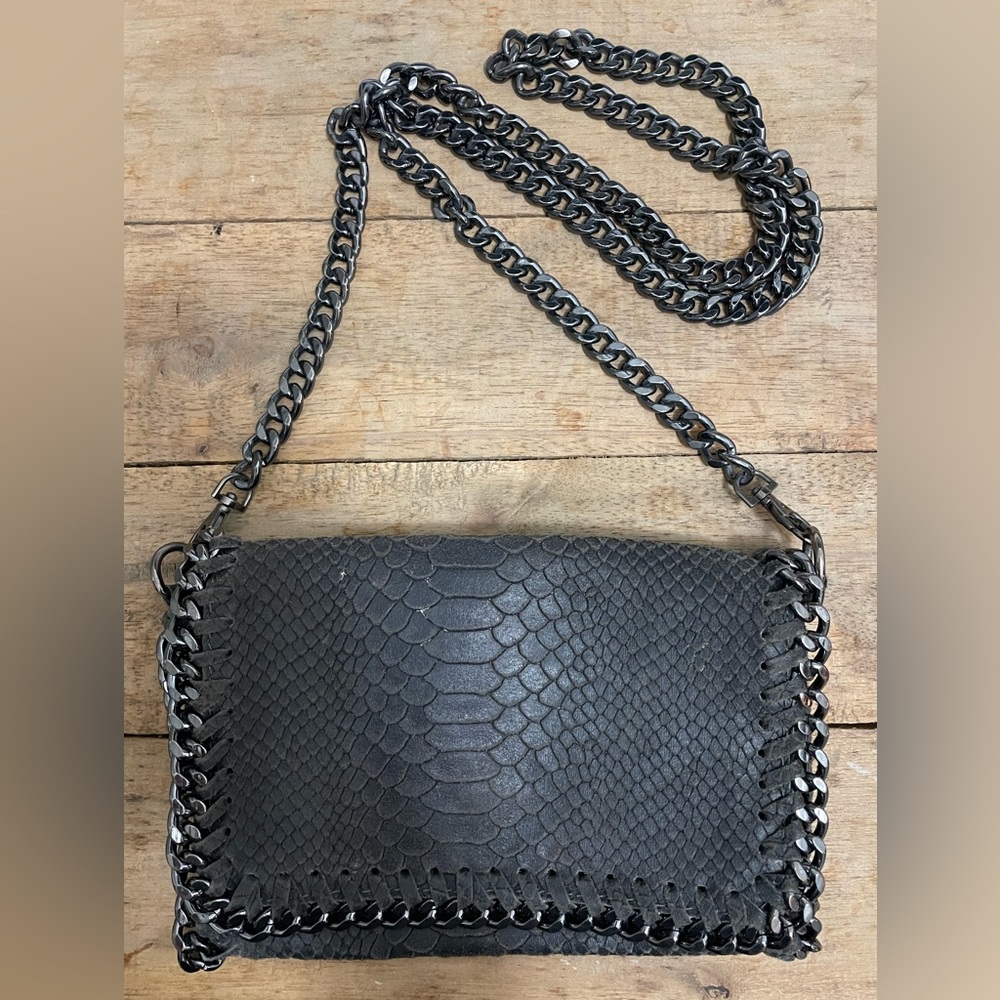 Authentic Italian leather cross body bag featuring silver tone chain trims